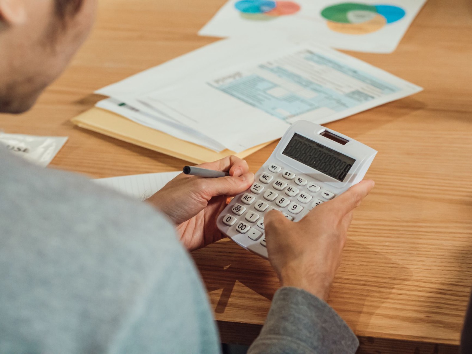 Calculatrice et facture posées sur un bureau pour vérifier les montants